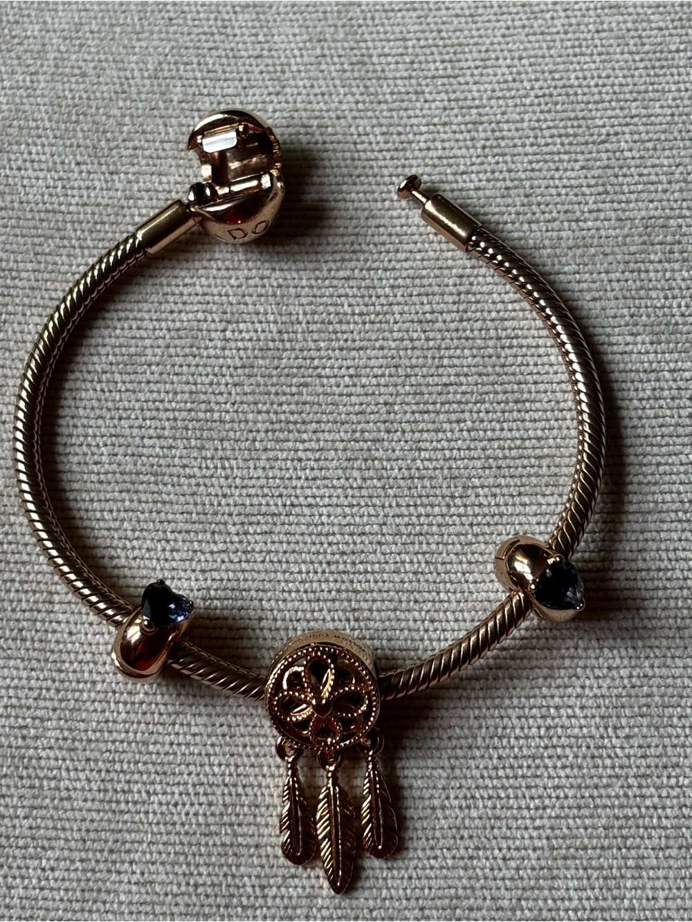 14k Rose plated Charm Bracelet w/Dreamcatch and clips with blue hearts. 6.3
